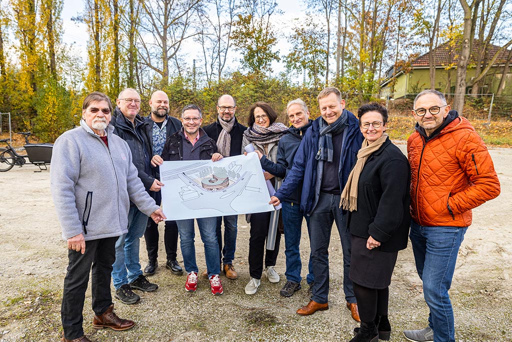 Eine Gruppe von Personen präsentiert zusammen mit dem OB die Ansicht des neuen Trägerhauses
