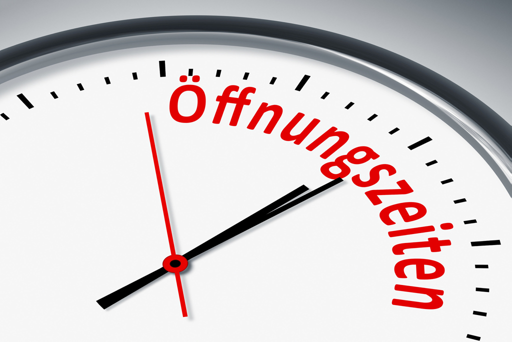 Eine Uhr mit dem Wort "Öffnungszeiten" auf dem Zifferblatt