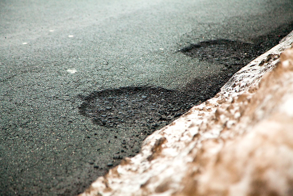 Schlaglöcher auf einer Straße Schlaglöcher auf einer Straße